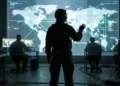 A conceptual silhouette of a female intelligence operative in a command center.