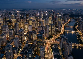 A dense urban skyline with luxury high-rise buildings at sunset.