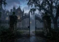 A gothic iron gate in front of a misty academy building at twilight.