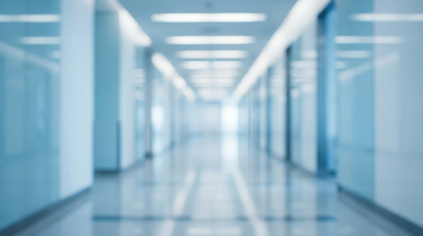 A blurred hospital hallway representing a medical setting.